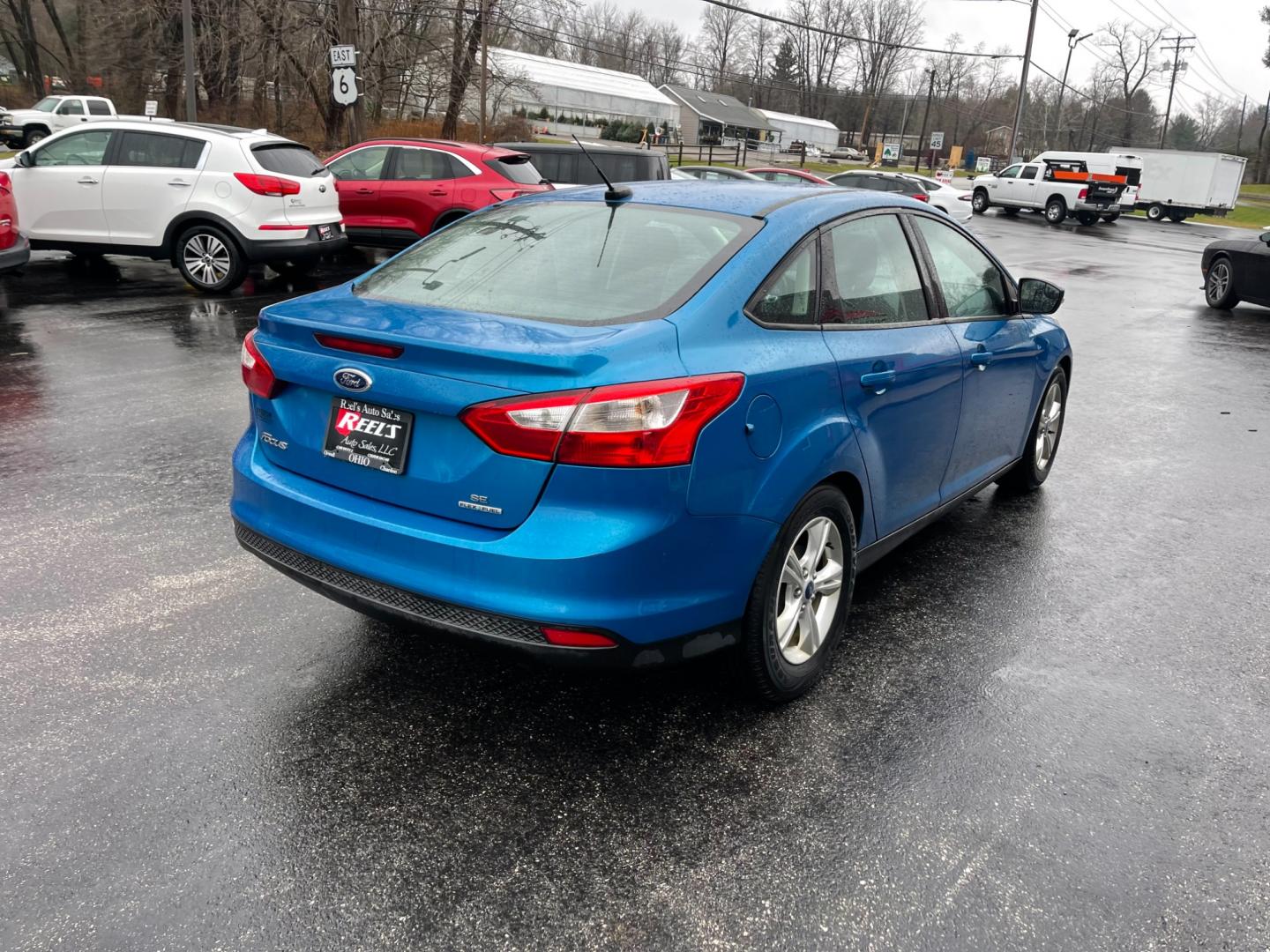 2014 Blue /Black Ford Focus SE Sedan (1FADP3F2XEL) with an 2.0L I4 DOHC 16V FFV engine, 6-Speed Automatic transmission, located at 547 E. Main St., Orwell, OH, 44076, (440) 437-5893, 41.535435, -80.847855 - Photo#7